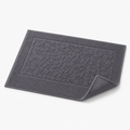 Tapis de bain à relief minéral